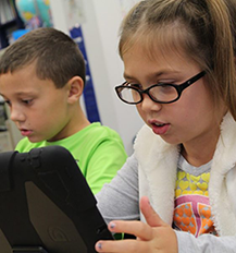Student Reading on Tablet